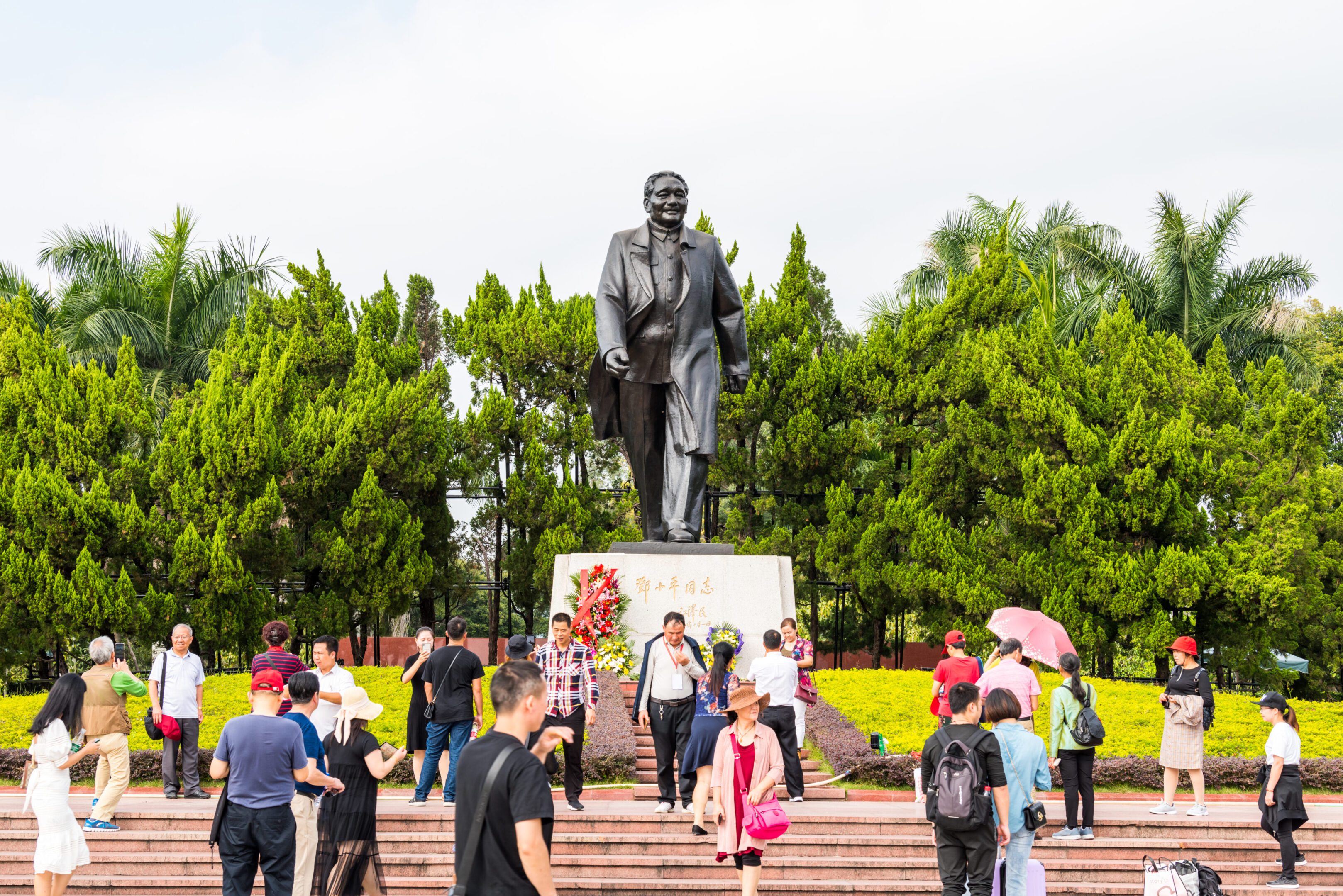 Lots of tourists taking photos in front of statue of Mr Deng Xiaoping in Lianhuashan Park of Shenzhen, the leader who was leading China's Reform and Opening-up.